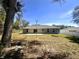 Backyard showing a light pole and some mature trees at 416 Marion Oaks Crse, Ocala, FL 34473