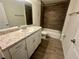 Bathroom featuring tile floors, large vanity, mirror, and tiled shower with bathtub at 416 Marion Oaks Crse, Ocala, FL 34473