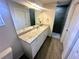 Bathroom featuring a large mirror over vanity, sink and drawers, and tiled walk-in shower at 416 Marion Oaks Crse, Ocala, FL 34473