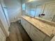 Bathroom featuring a large mirror over vanity, sink and drawers, and tiled walk-in shower at 416 Marion Oaks Crse, Ocala, FL 34473