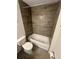 Bathroom featuring shower with bathtub, gray tile walls and updated fixtures at 416 Marion Oaks Crse, Ocala, FL 34473