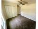 Carpeted bedroom featuring a ceiling fan and a closet offering storage space at 416 Marion Oaks Crse, Ocala, FL 34473