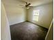 Carpeted bedroom with ceiling fan and a window providing natural light at 416 Marion Oaks Crse, Ocala, FL 34473
