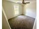 Bright bedroom with carpet, ceiling fan, and a window providing natural light at 416 Marion Oaks Crse, Ocala, FL 34473