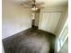 Carpeted bedroom featuring a ceiling fan and a closet offering storage space at 416 Marion Oaks Crse, Ocala, FL 34473