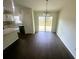 Open dining room adjacent to kitchen featuring dark wood floors and glass doors to backyard at 416 Marion Oaks Crse, Ocala, FL 34473