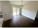 Open dining room featuring dark wood floors and sliding glass doors to backyard at 416 Marion Oaks Crse, Ocala, FL 34473