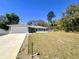 Charming single-story home with a well-maintained lawn and a two-car garage on a sunny day at 416 Marion Oaks Crse, Ocala, FL 34473