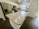 Bright kitchen with stainless steel appliances, white cabinets, and large island with stone countertop at 416 Marion Oaks Crse, Ocala, FL 34473