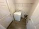 Laundry room features tile floors, a washer, shelving, and entry doors at 416 Marion Oaks Crse, Ocala, FL 34473