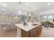Modern kitchen with island seating, stainless steel dishwasher, and open to the living and dining areas at 4497 Nw 54Th Ter, Ocala, FL 34482