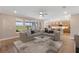 Bright and airy living room showcases an oversized sectional sofa, clear coffee table, and an open floor plan at 4497 Nw 54Th Ter, Ocala, FL 34482