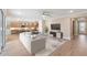 Open-concept living room with a modern sofa, stylish console, and seamless flow to the kitchen at 4497 Nw 54Th Ter, Ocala, FL 34482