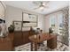 This office features a wooden desk, neutral walls, and a large abstract painting for a serene workspace at 4497 Nw 54Th Ter, Ocala, FL 34482