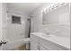 Traditional bathroom showcasing a vanity with a sink, tiled walls, and a shower-tub combo at 4516 Ne 8Th St, Ocala, FL 34470