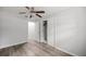 Bedroom showcasing wood-look floors, a ceiling fan, and a closet, offering modern comfort at 4516 Ne 8Th St, Ocala, FL 34470