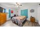 Cozy bedroom featuring warm wood-look floors, curtains, and a comfortable quilt bedspread at 4516 Ne 8Th St, Ocala, FL 34470