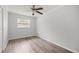 This bedroom features wood-look floors and a bright window, inviting natural light at 4516 Ne 8Th St, Ocala, FL 34470