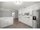 Bright kitchen with white cabinetry, updated appliances, and modern flooring at 4516 Ne 8Th St, Ocala, FL 34470