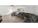 Comfortable living room with neutral decor, a large sectional sofa, and lots of natural light at 4516 Ne 8Th St, Ocala, FL 34470