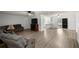 Open-concept living area with sleek flooring, a ceiling fan, and access to the kitchen at 4516 Ne 8Th St, Ocala, FL 34470