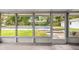 View from the covered patio through the screen to the covered pool at 4516 Ne 8Th St, Ocala, FL 34470