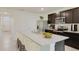 Modern kitchen featuring stainless steel appliances, a large island, and dark wood cabinets at 4754 Sw 88Th Ln, Ocala, FL 34476