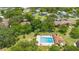 Aerial view of the community with pool, lush landscaping, and mature trees at 501 Fairways Ln # A, Ocala, FL 34472