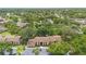 Aerial view of the condo buildings surrounded by mature trees and ample parking spaces at 501 Fairways Ln # A, Ocala, FL 34472
