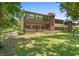Exterior backyard featuring a screened-in lanai with lawn at 501 Fairways Ln # A, Ocala, FL 34472