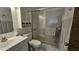 Clean bathroom with glass enclosed shower, white vanity, and coordinated accessories at 501 Fairways Ln # A, Ocala, FL 34472