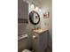 Cozy bathroom featuring a decorative mirror, white vanity, and neutral countertop at 501 Fairways Ln # A, Ocala, FL 34472