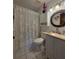 Well-lit bathroom with a vanity, decorative mirror, and shower-tub combo at 501 Fairways Ln # A, Ocala, FL 34472