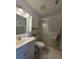 Bathroom featuring a vanity, toilet, and a glass-enclosed shower at 501 Fairways Ln # A, Ocala, FL 34472