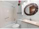 Bathroom featuring a granite countertop vanity, decorative mirror, and shower with grab bar at 501 Fairways Ln # A, Ocala, FL 34472