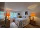 Bright bedroom featuring a cozy queen bed, matching nightstands, and a sunny window at 501 Fairways Ln # A, Ocala, FL 34472