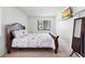 Comfortable bedroom featuring a plush bed, a window with blinds, and a mounted TV at 501 Fairways Ln # A, Ocala, FL 34472