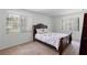 Cozy bedroom with a large window, carpet floor, and simple furniture at 501 Fairways Ln # A, Ocala, FL 34472