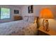 Bright bedroom with floral bedding, dresser, and natural light from the window at 501 Fairways Ln # A, Ocala, FL 34472