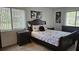 Comfortable bedroom featuring a queen-sized bed, nightstands, and two windows with blinds at 501 Fairways Ln # A, Ocala, FL 34472