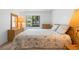 Relaxing bedroom featuring a view from the window, lamps on each side, and a comfortable bed at 501 Fairways Ln # A, Ocala, FL 34472