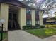 Two story condo building featuring a stucco exterior, dark brown trim, and lush lawn at 501 Fairways Ln # A, Ocala, FL 34472
