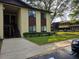 A view of a yellow and brown two-story condo building with stairs and a walkway at 501 Fairways Ln # A, Ocala, FL 34472