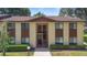 Exterior of a two-story building with neutral paint, brown trim, and well-maintained landscaping at 501 Fairways Ln # A, Ocala, FL 34472