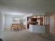 Open-concept dining room with wicker furniture adjacent to the kitchen at 501 Fairways Ln # A, Ocala, FL 34472