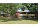 View of the property showcasing its exterior with mature trees and landscaping at 501 Fairways Ln # A, Ocala, FL 34472