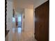 Inviting hallway with tile flooring and closet, leading to a bedroom with natural light at 501 Fairways Ln # A, Ocala, FL 34472