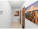 Clean hallway with tile floor and art decorations on white walls at 501 Fairways Ln # A, Ocala, FL 34472