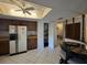 Functional kitchen with tile floors, a pantry, and pass-through to the dining area at 501 Fairways Ln # A, Ocala, FL 34472
