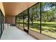 Screened lanai providing a serene outdoor space with views of the lush green lawn at 501 Fairways Ln # A, Ocala, FL 34472